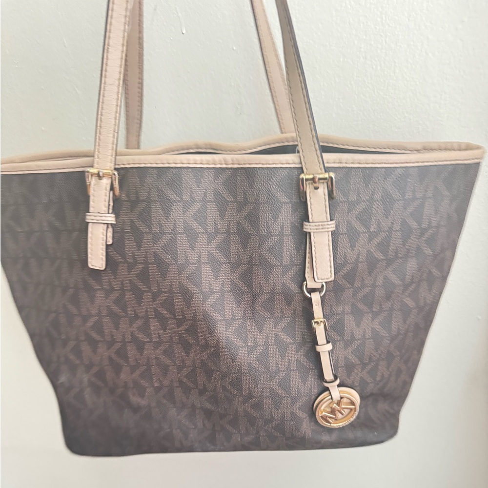 Michael core brown, and tan signature bag with the charm